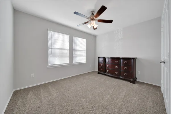 a living room with furniture and a ceiling fan