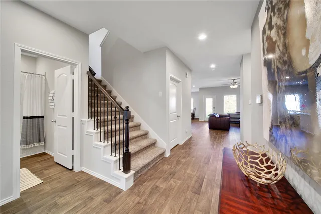 a view of entryway and hall with wooden floor