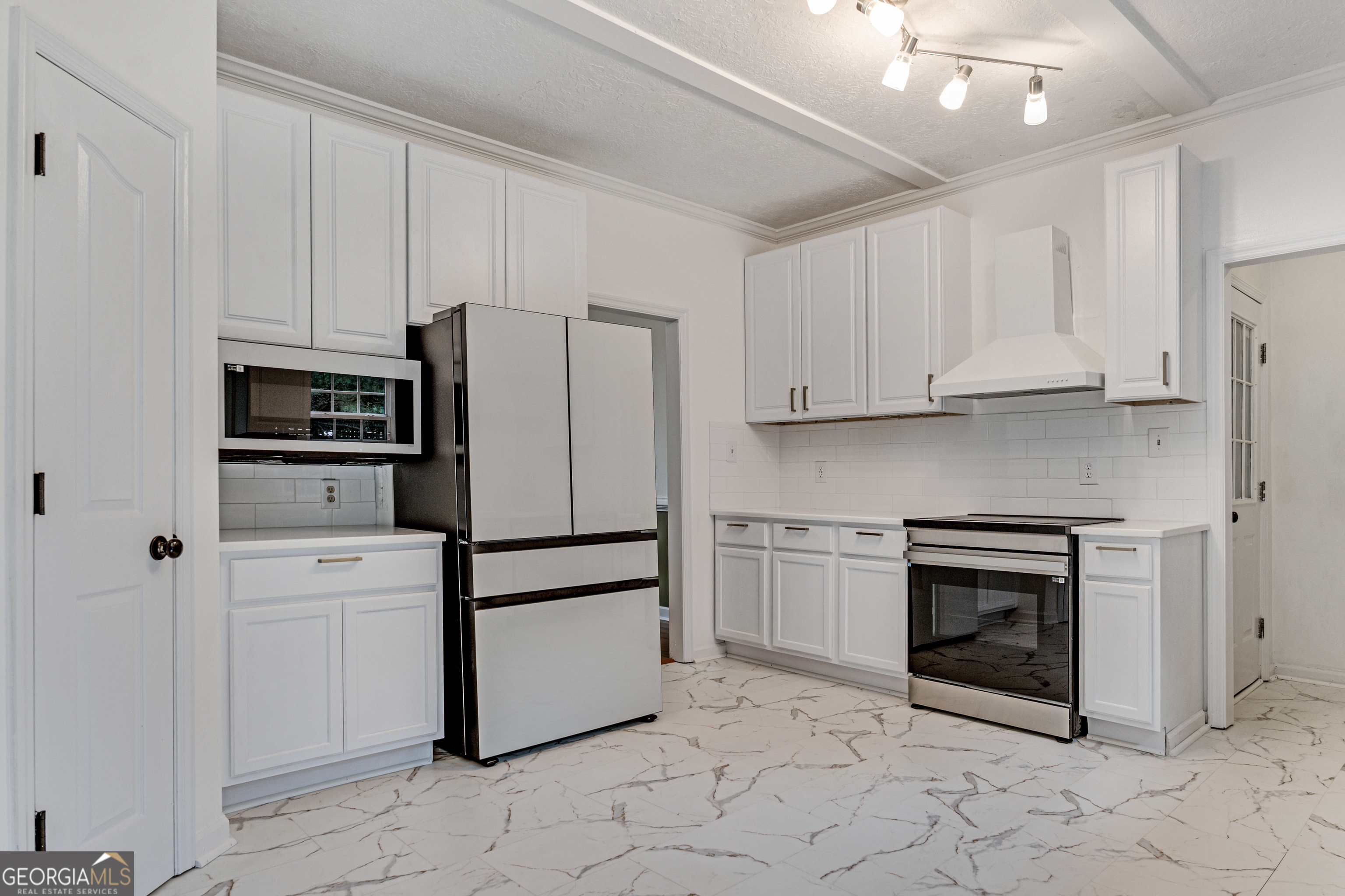 2535 Sand Ridge Court Hephzibah, GA 30815 - Photo 14 of 41 a white refrigerator freezer and a stove in a kitchen