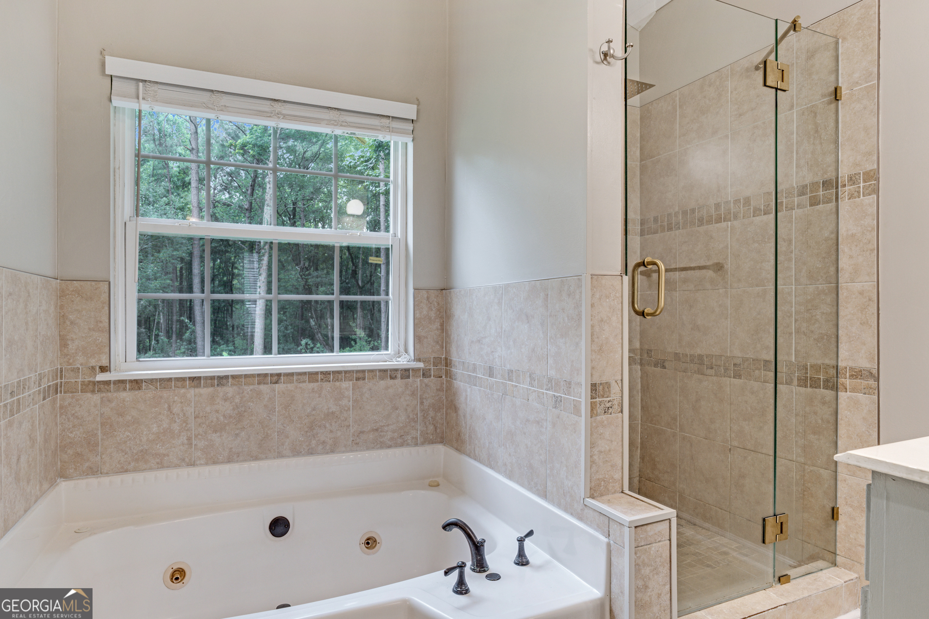 2535 Sand Ridge Court Hephzibah, GA 30815 - Photo 29 of 41 a bathroom with a tub and a shower