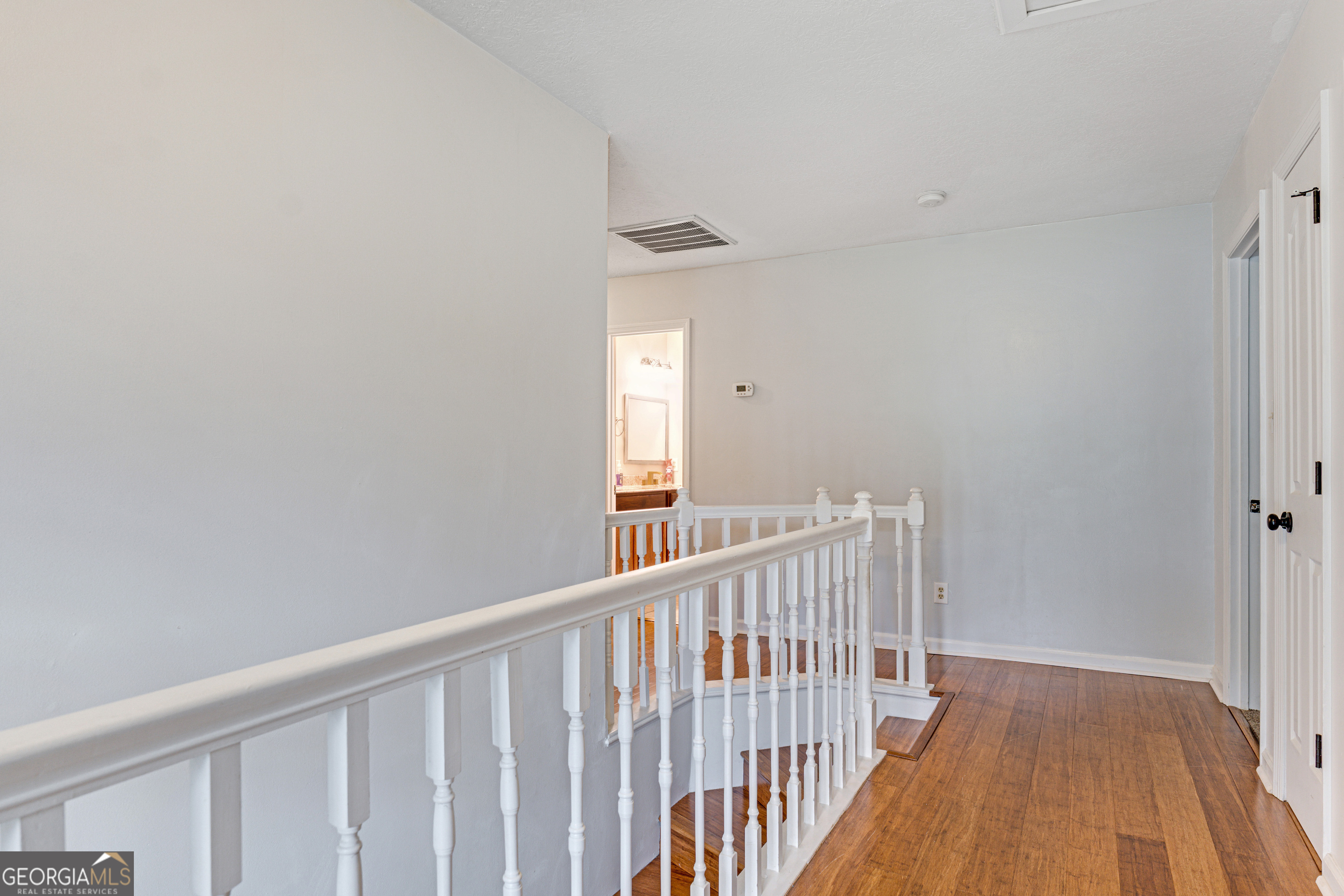 2535 Sand Ridge Court Hephzibah, GA 30815 - Photo 35 of 41 a view of a hallway with wooden floor and a bathroom