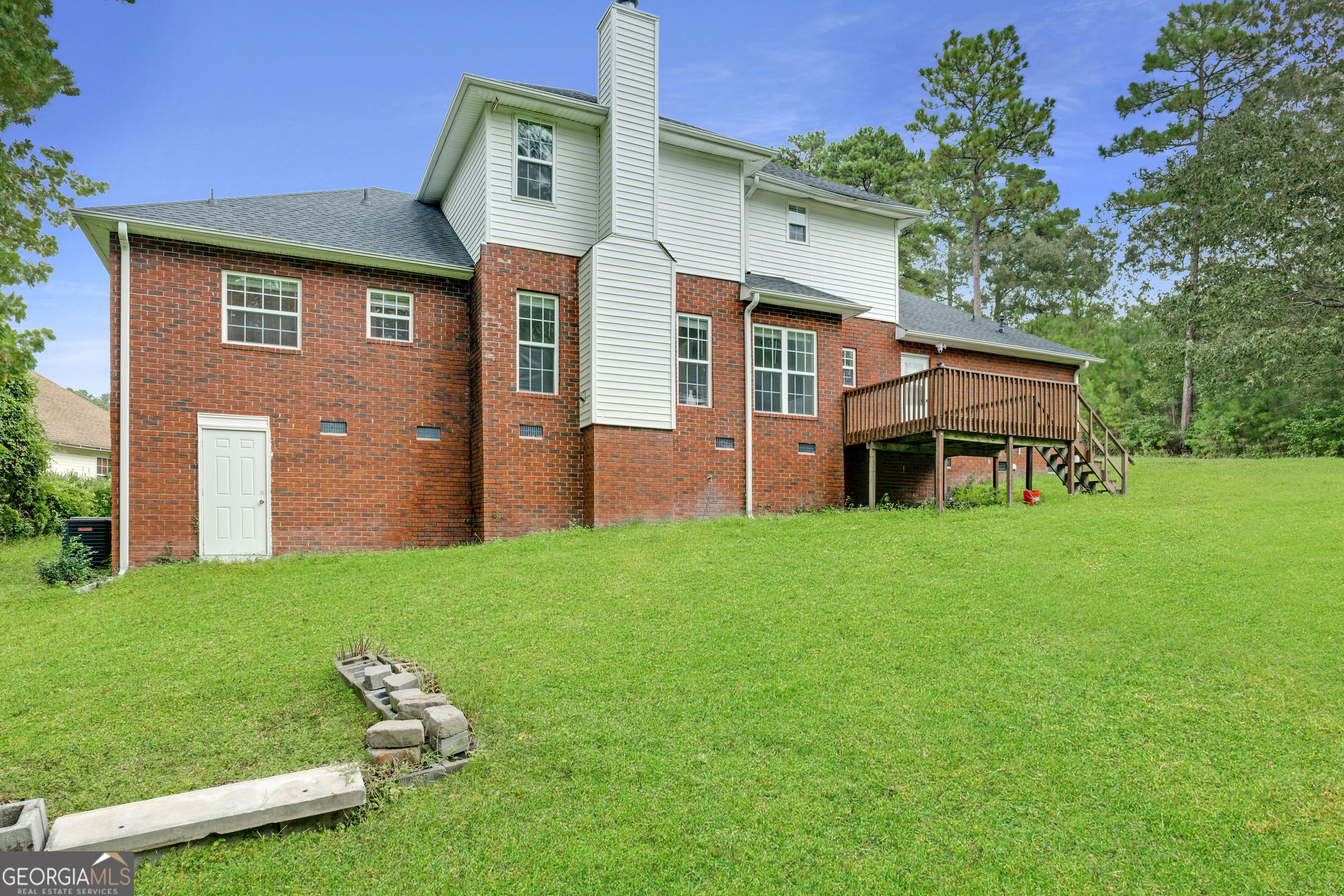 2535 Sand Ridge Court Hephzibah, GA 30815 - Photo 5 of 41 a front view of a house with a garden and plants