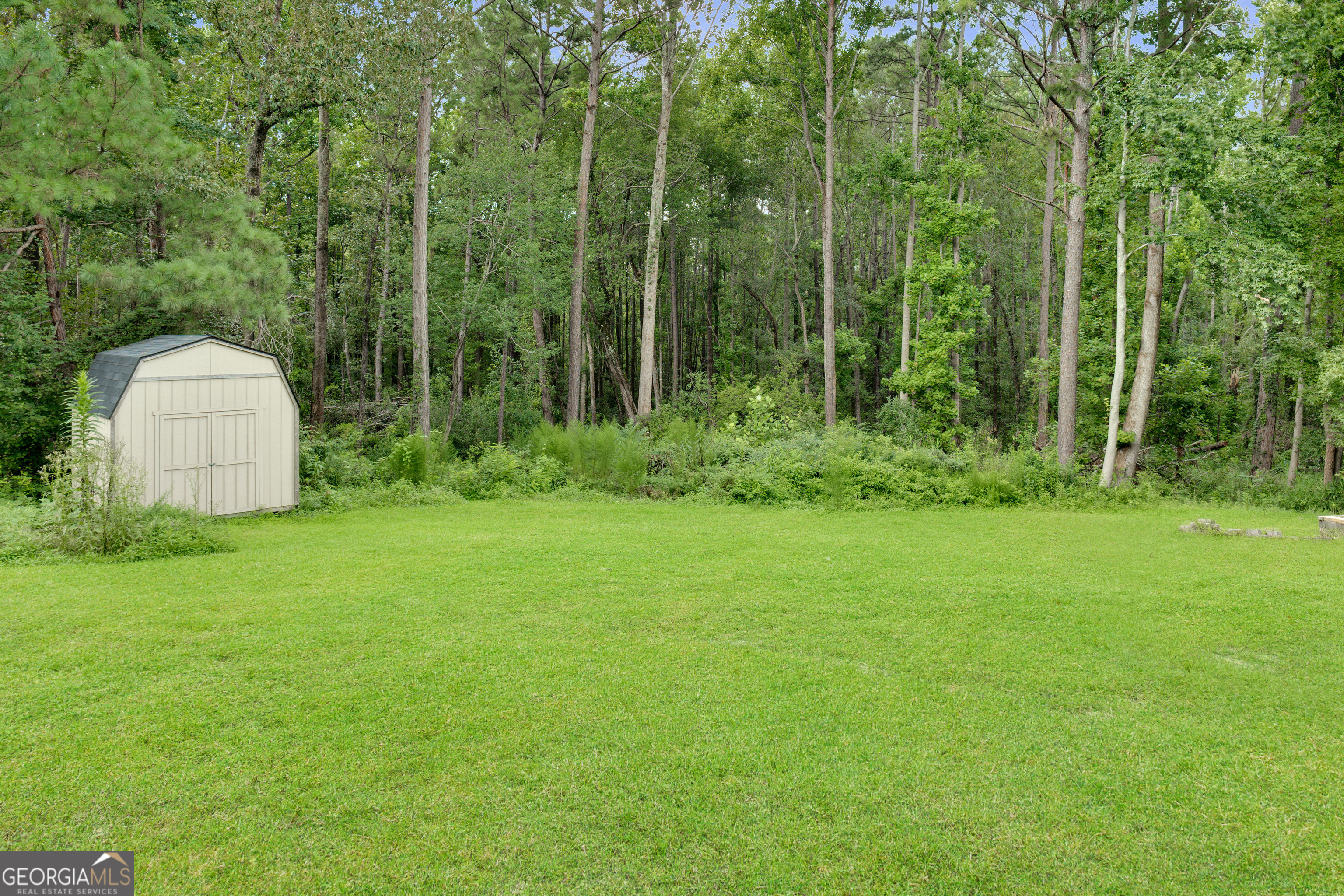 2535 Sand Ridge Court Hephzibah, GA 30815 - Photo 6 of 41 a view of a backyard with a garden and entertaining space