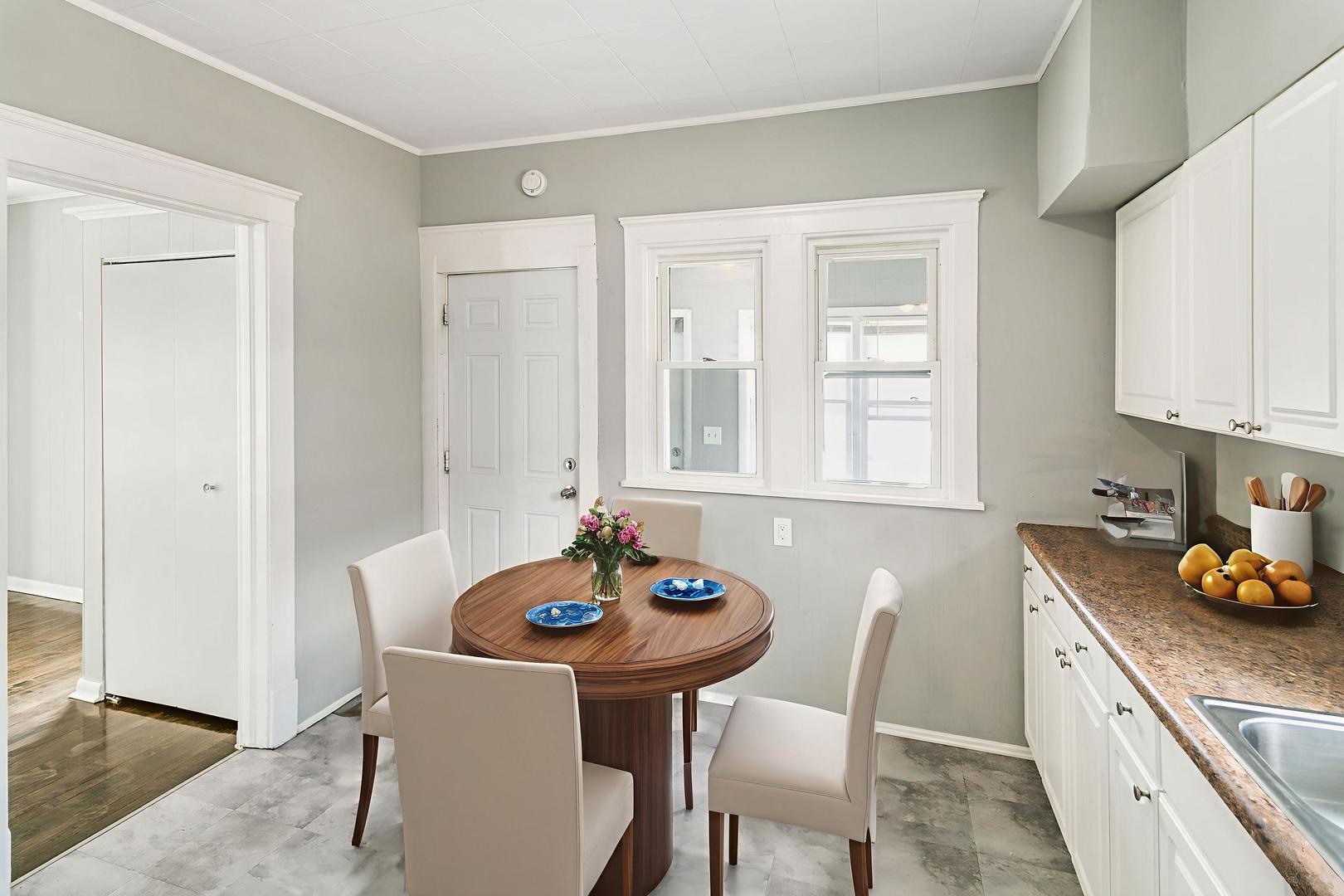 705 Nicholson Street Joliet, IL 60435 - Photo 8 of 26 a kitchen with stainless steel appliances kitchen island granite countertop a sink and white cabinets