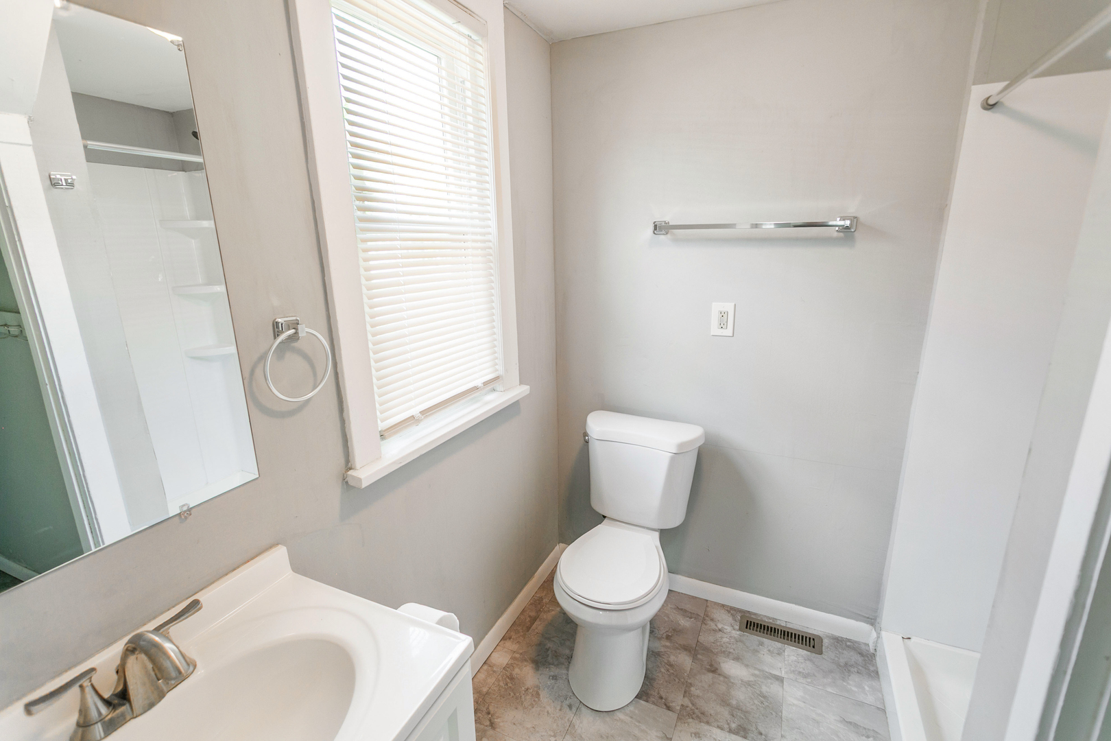 705 Nicholson Street Joliet, IL 60435 - Photo 9 of 26 a bathroom with a toilet sink and a mirror