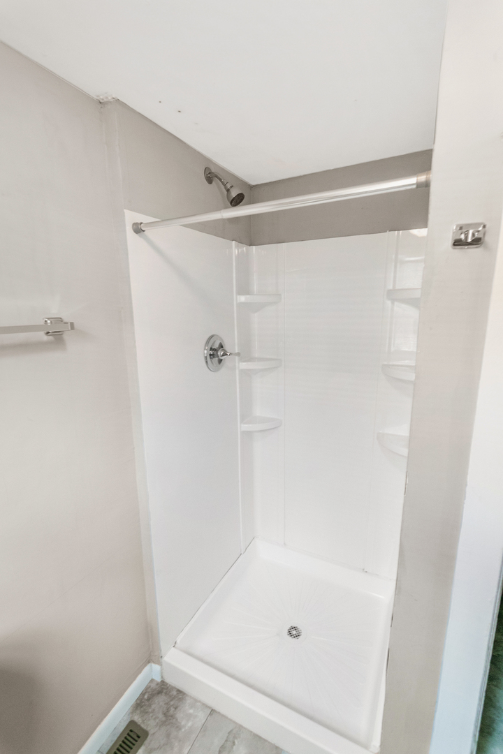 705 Nicholson Street Joliet, IL 60435 - Photo 10 of 26 a bathroom with a glass shower door