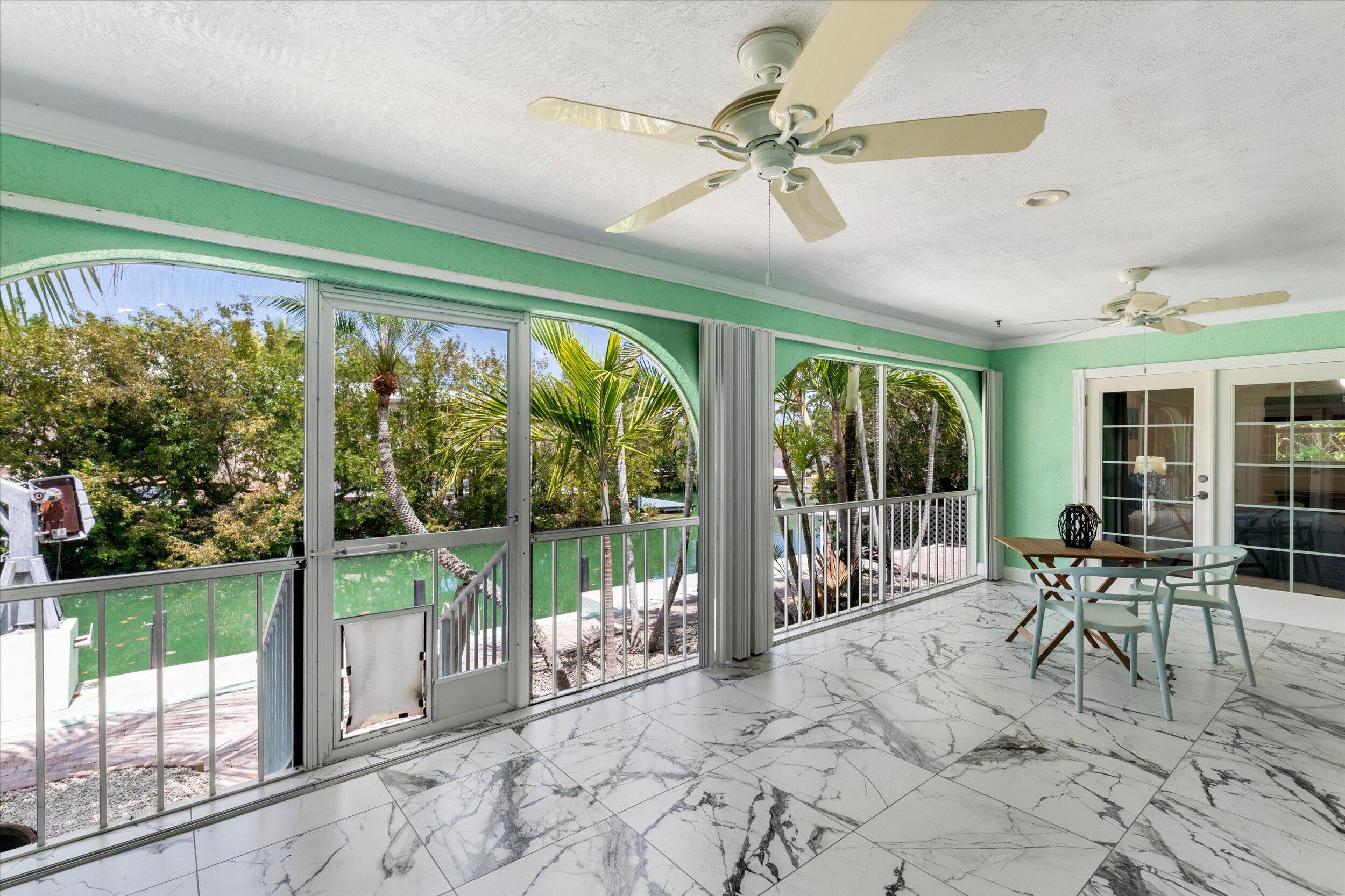 21025 3rd Avenue Cudjoe, FL 33042 - Photo 12 of 43 a view of a porch with chairs and backyard