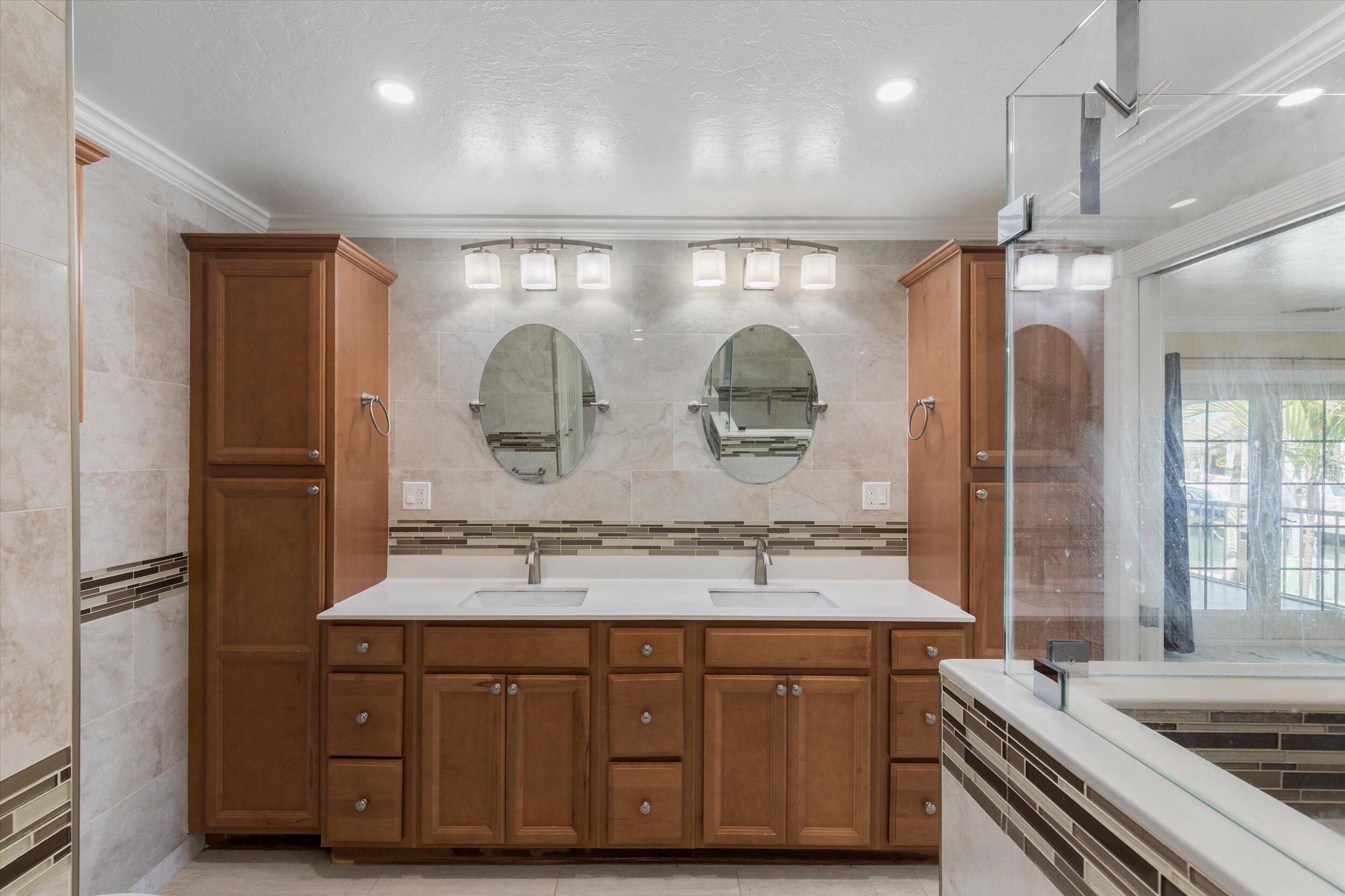 21025 3rd Avenue Cudjoe, FL 33042 - Photo 19 of 43 a bathroom with a granite countertop sink a mirror and a shower