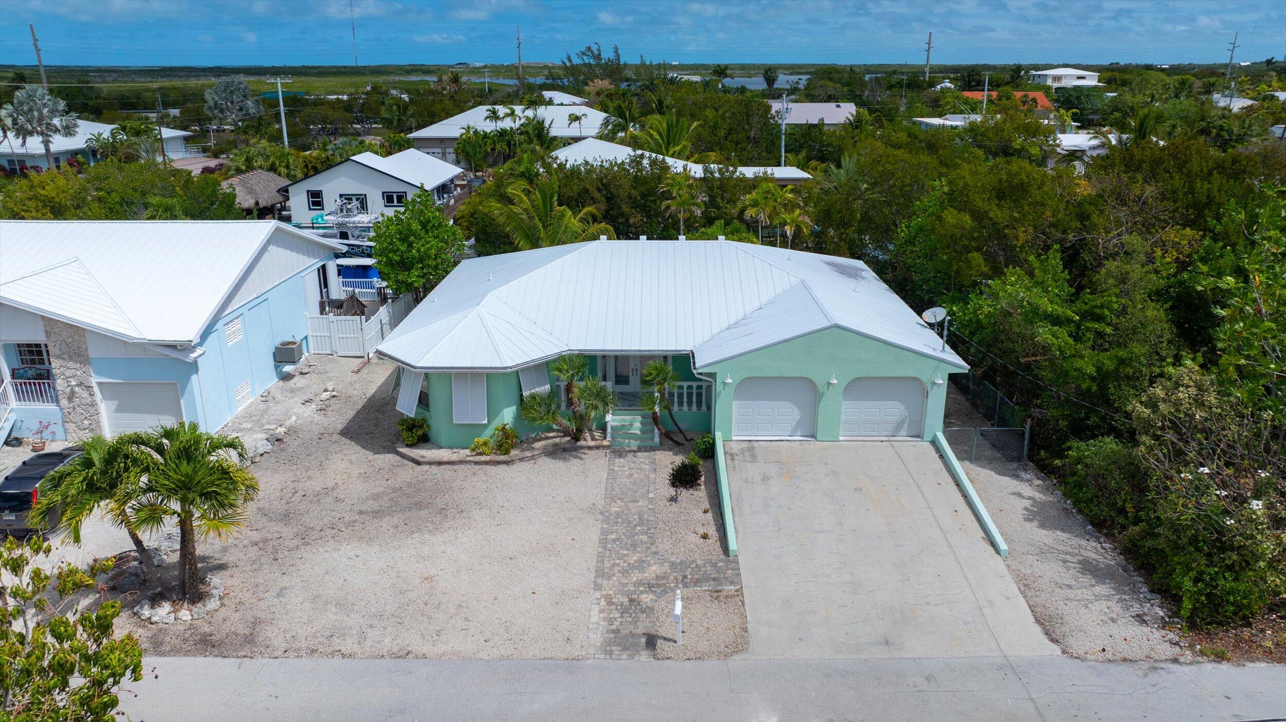 21025 3rd Avenue Cudjoe, FL 33042 - Photo 34 of 43 an aerial view of a house with yard patio and lake view