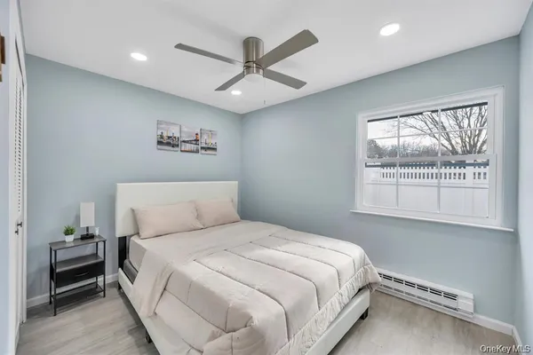 a bedroom with a large bed and a window