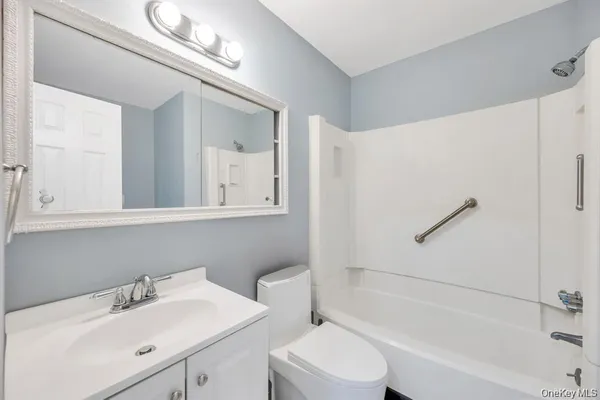 a bathroom with a sink mirror vanity and toilet