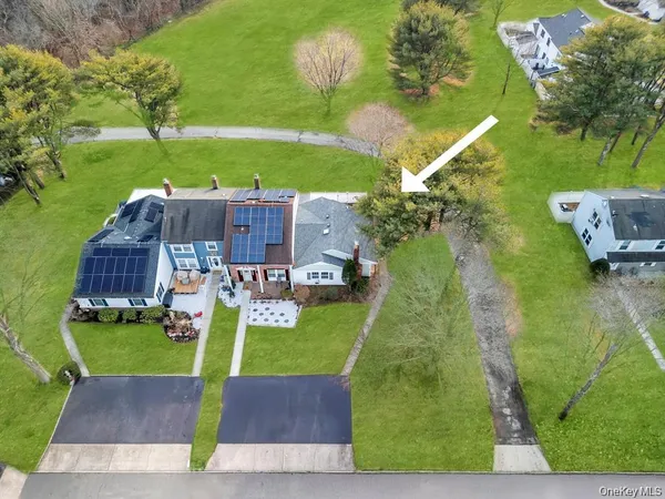 an aerial view of a house with garden space pool seating area and yard