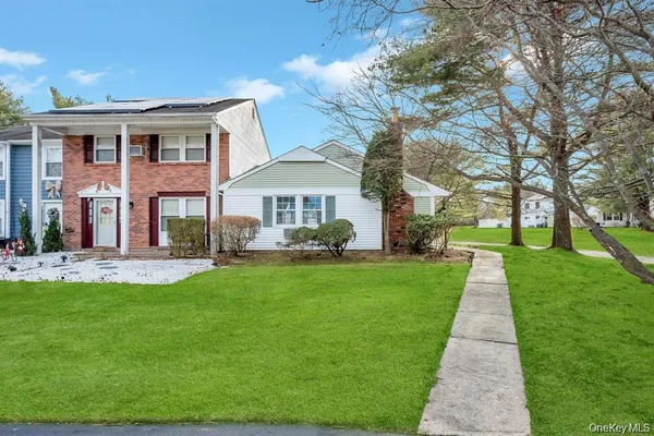 a front view of house with yard and green space