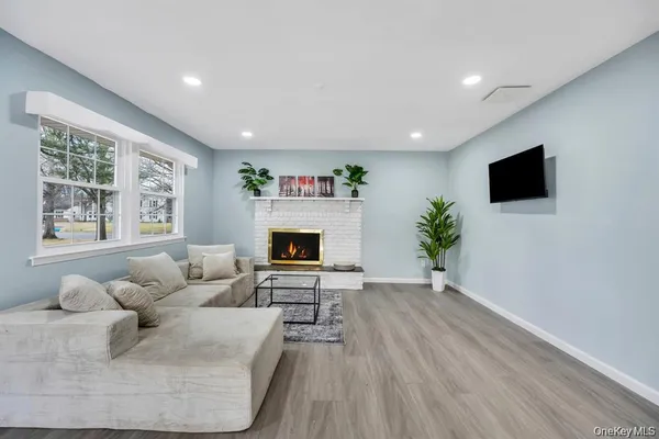 a living room with furniture a flat screen tv and a fireplace