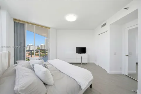 a bedroom with a bed and a television