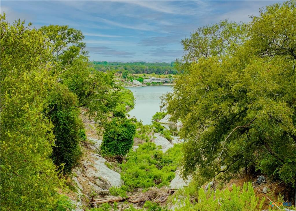 29 Artesian Drive Belton, TX 76513 - Photo 3 of 6 a view of a lake with a building in the background