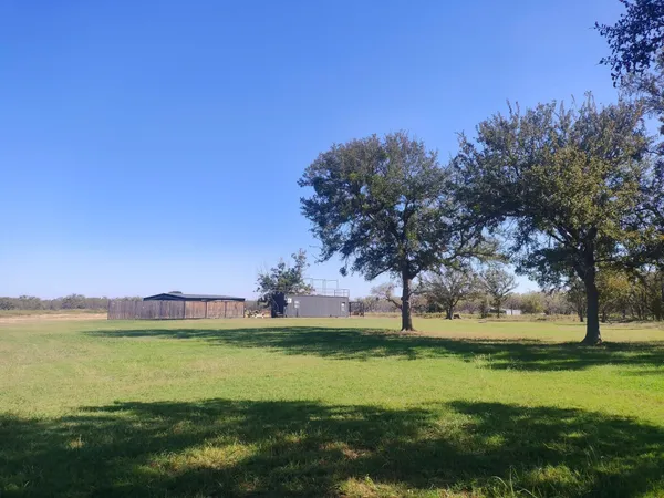 a view of yard with swimming pool and green space