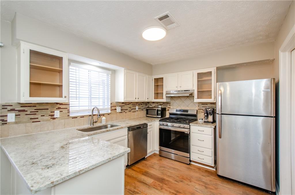 1066 Wedgewood Lane Tucker, GA 30084 - Photo 11 of 23 a kitchen with a stove a sink and a refrigerator