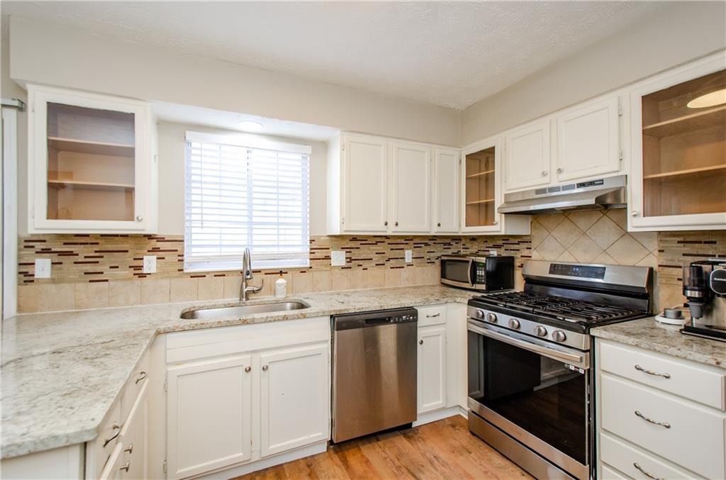 1066 Wedgewood Lane Tucker, GA 30084 - Photo 12 of 23 a kitchen with cabinets appliances a sink and a window
