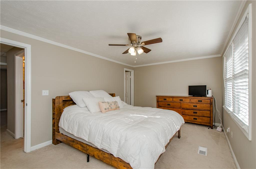1066 Wedgewood Lane Tucker, GA 30084 - Photo 21 of 23 a bedroom with a bed and a chandelier
