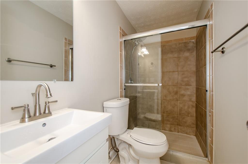 1066 Wedgewood Lane Tucker, GA 30084 - Photo 23 of 23 a bathroom with a sink mirror toilet and shower