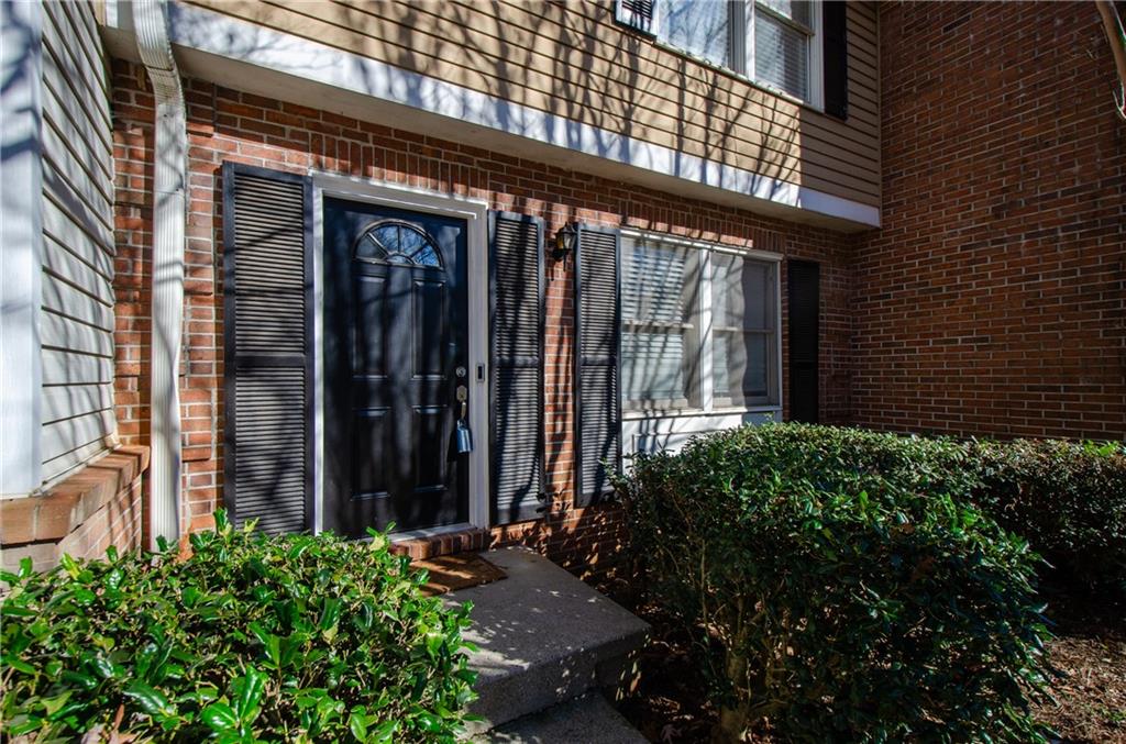 1066 Wedgewood Lane Tucker, GA 30084 - Photo 3 of 23 a front view of a house with a garden