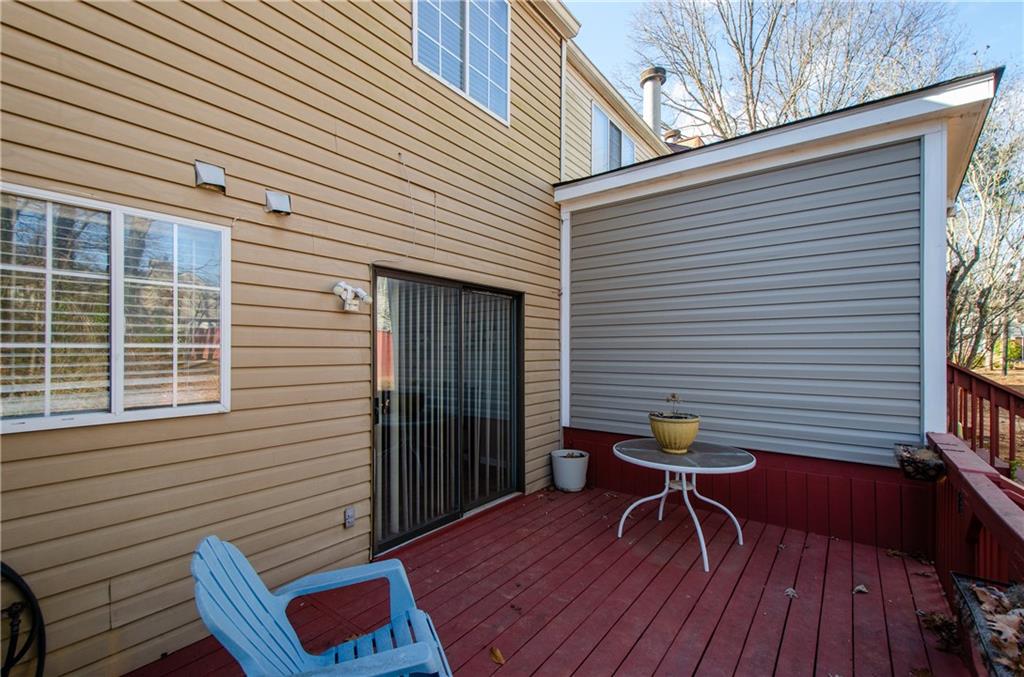 1066 Wedgewood Lane Tucker, GA 30084 - Photo 7 of 23 a view of a deck with a table and chairs and wooden floor