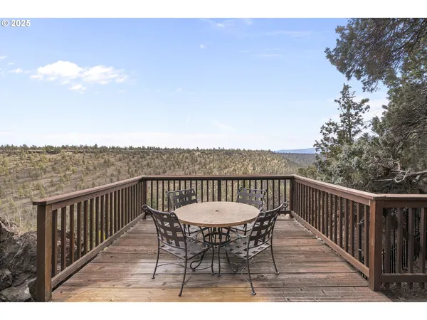 a balcony with table and chairs