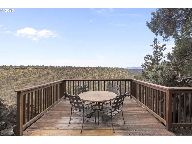 a balcony with table and chairs