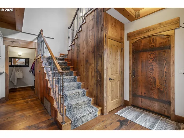 a kitchen with a table chairs and a wooden floor