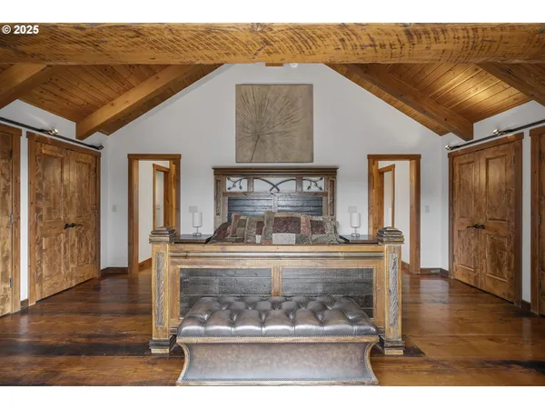 a spacious bedroom with a bed and a window