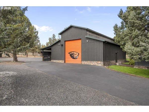 a kitchen with stainless steel appliances granite countertop a sink a microwave refrigerator and stove