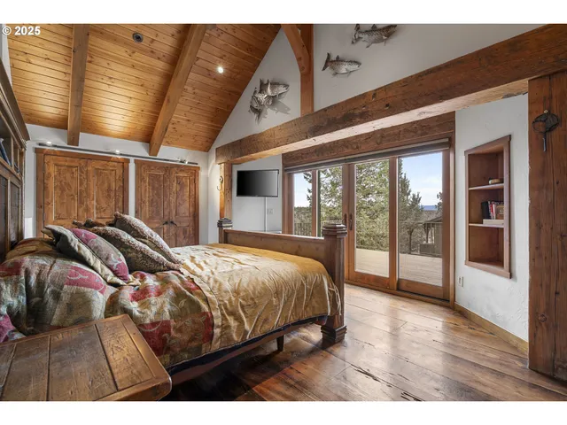 a bed room with a bed and a large window