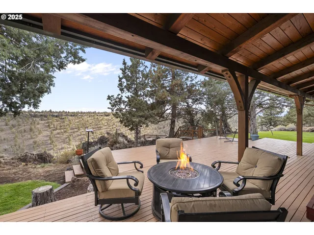 a view of a patio with furniture and a backyard