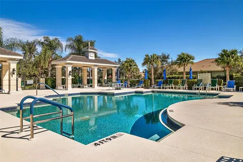 a view of a patio with table and chairs under an umbrella