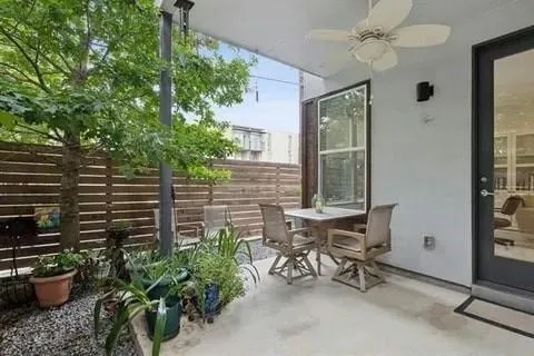 a view of a patio with table and chairs and potted plants