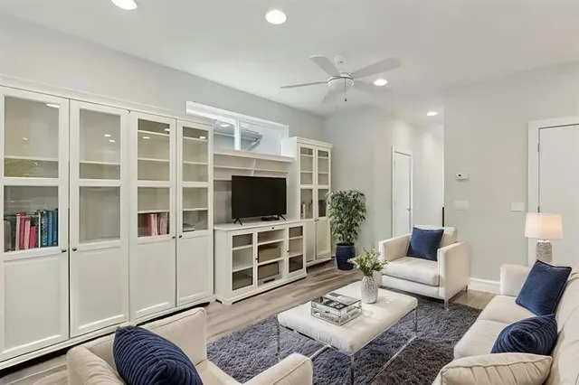 a living room with furniture a rug and a flat screen tv