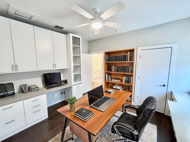 a room with furniture a flat screen tv and a window