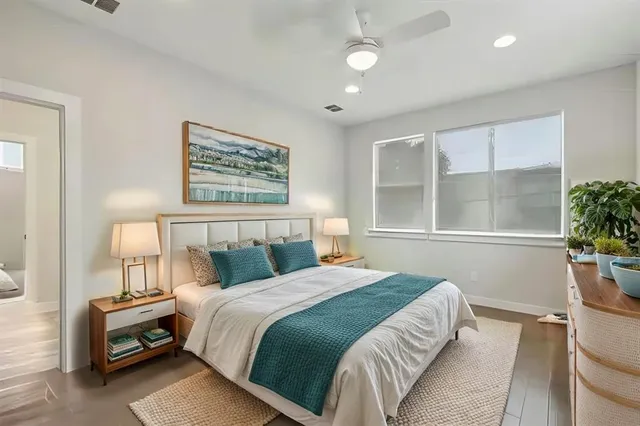 a bedroom with bed and a potted plant