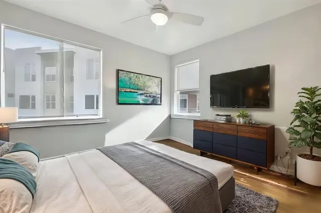 a bedroom with a large bed and a flat screen tv