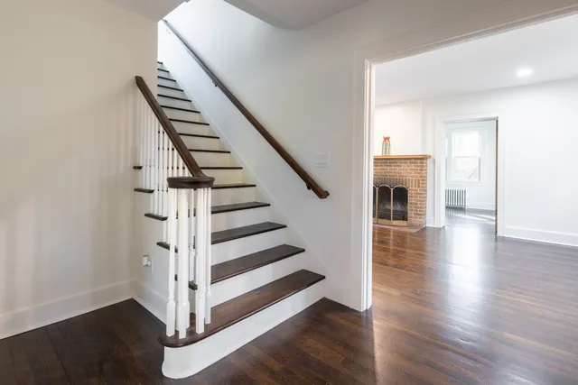 a view of entryway and hall with wooden floor