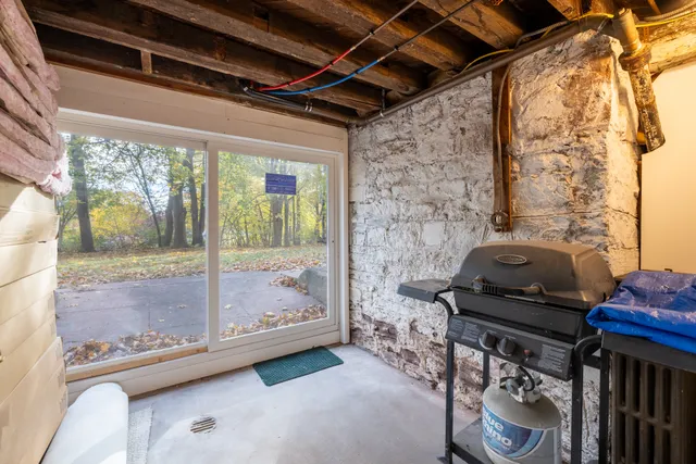 a view of a room with wooden floor and furniture