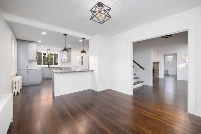 a view of a kitchen with wooden floor and a kitchen