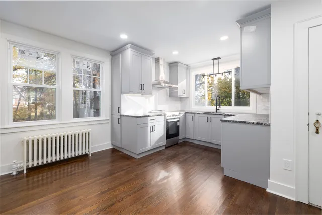 a kitchen with a sink window and cabinets