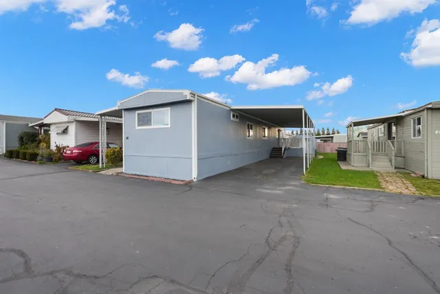 a view of a house with a yard and garage