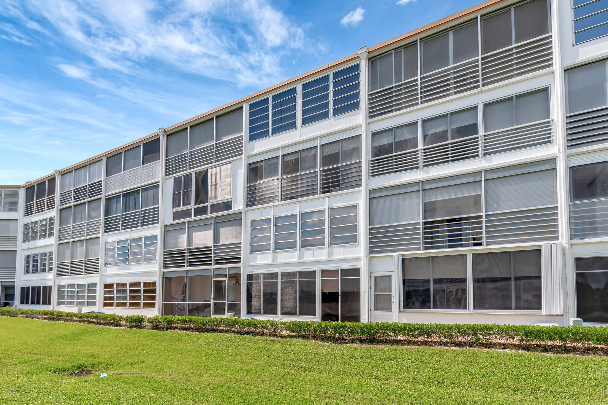 3031 Cornwall East Boca Raton, FL 33434 - Photo 32 of 84 front view of a building with a yard