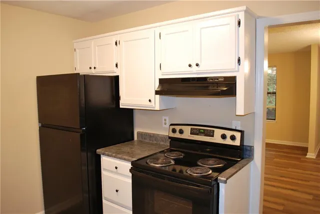 a kitchen with a stove and a refrigerator