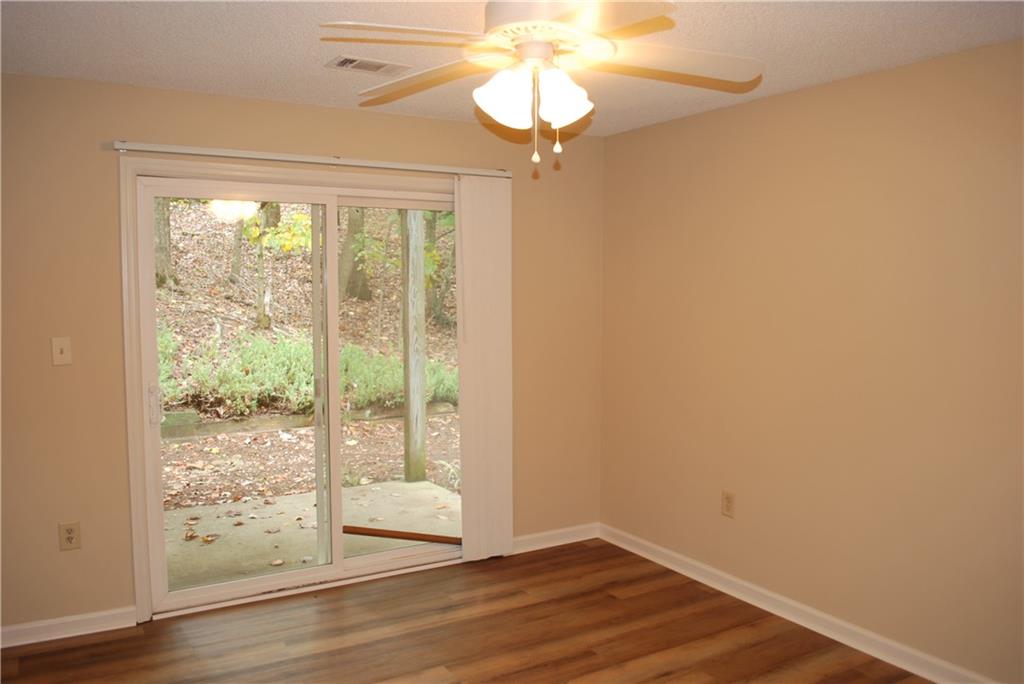 2235 Old Hamilton Place Gainesville, GA 30507 - Photo 10 of 12 a view of an empty room with wooden floor and fan