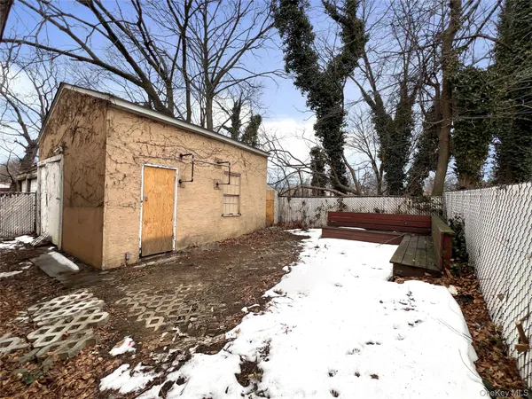 a view of a white house with a yard covered in snow
