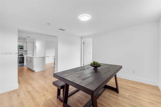 a view of a kitchen with a table and chairs